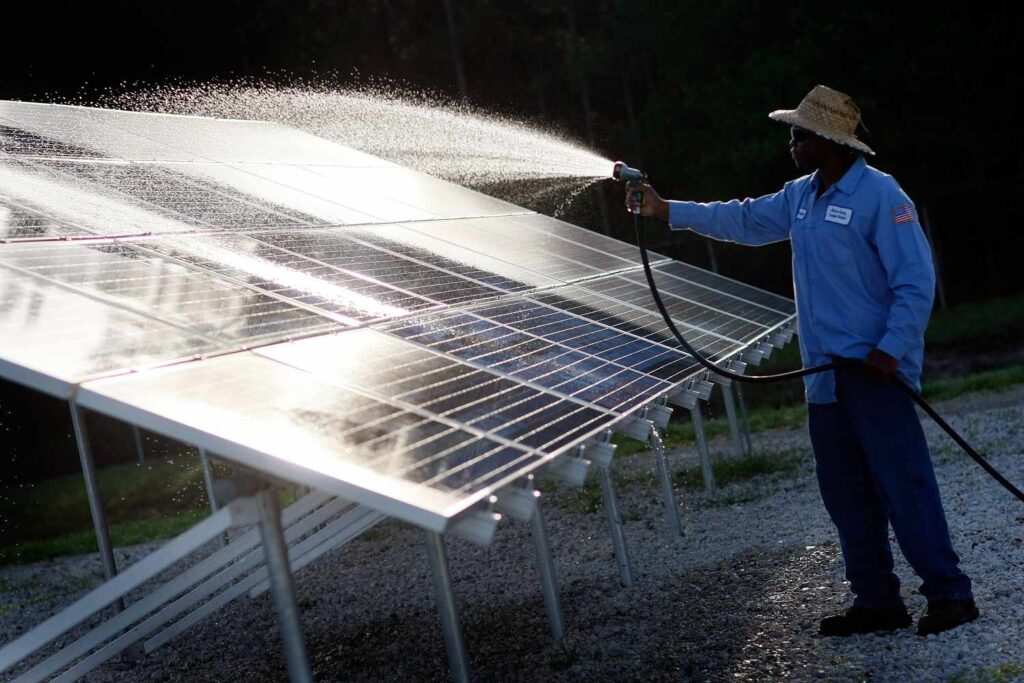 black man wash solar panels system