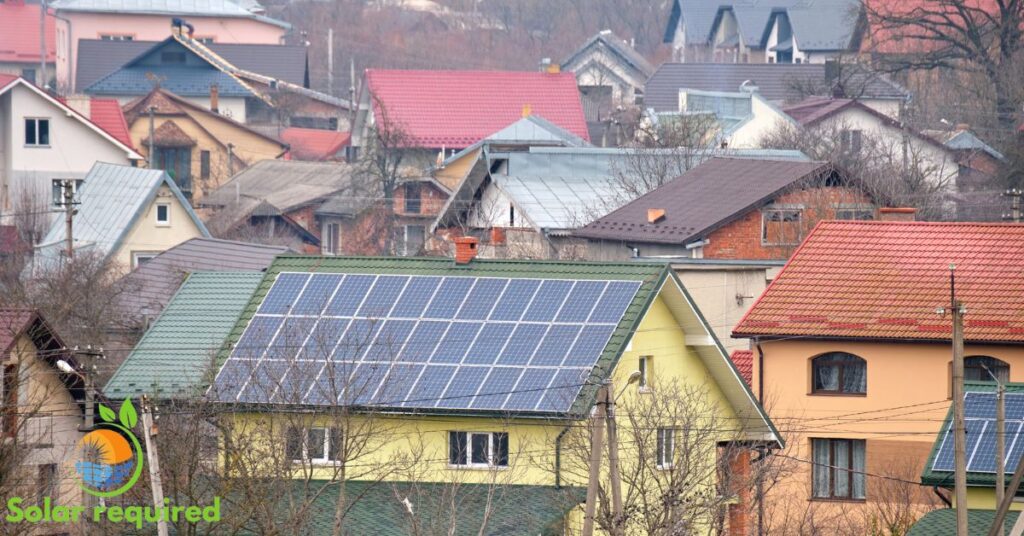 Solar panels on rooftops in a town, harnessing renewable energy to power homes and reduce carbon footprint.
