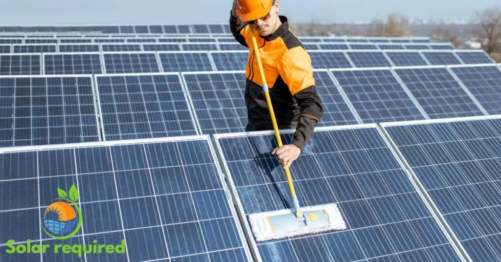 a man is cleaning solar panels