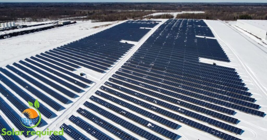 Solar panels covered in snow on a rooftop, providing clean energy despite winter weather.