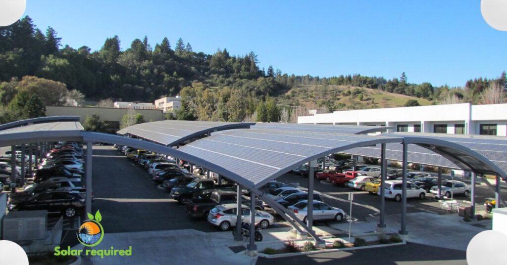 Cars parked under a solar canopy in a parking lot.