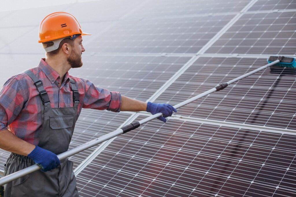 man clean solar panel