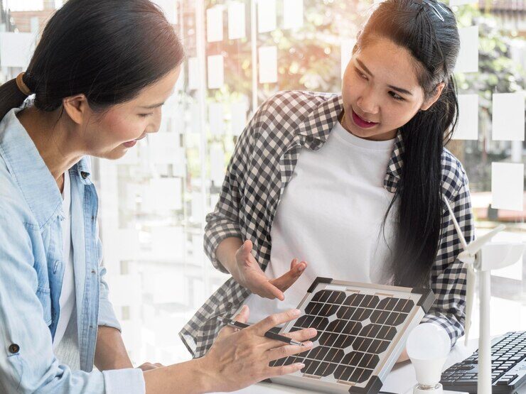 a woman showing a solar panel to another woman